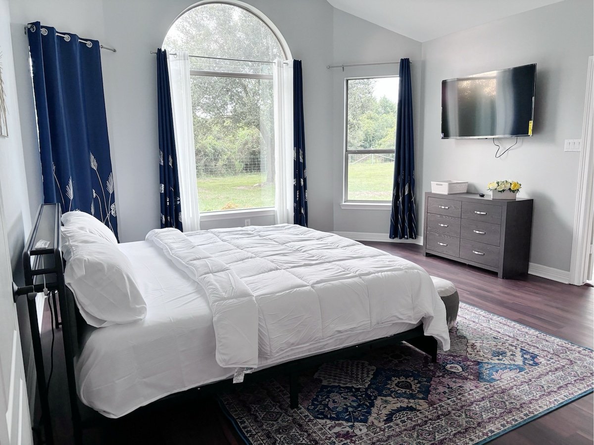 Master suite with French windows, walk-in closet, Jacuzzi, and smart TV