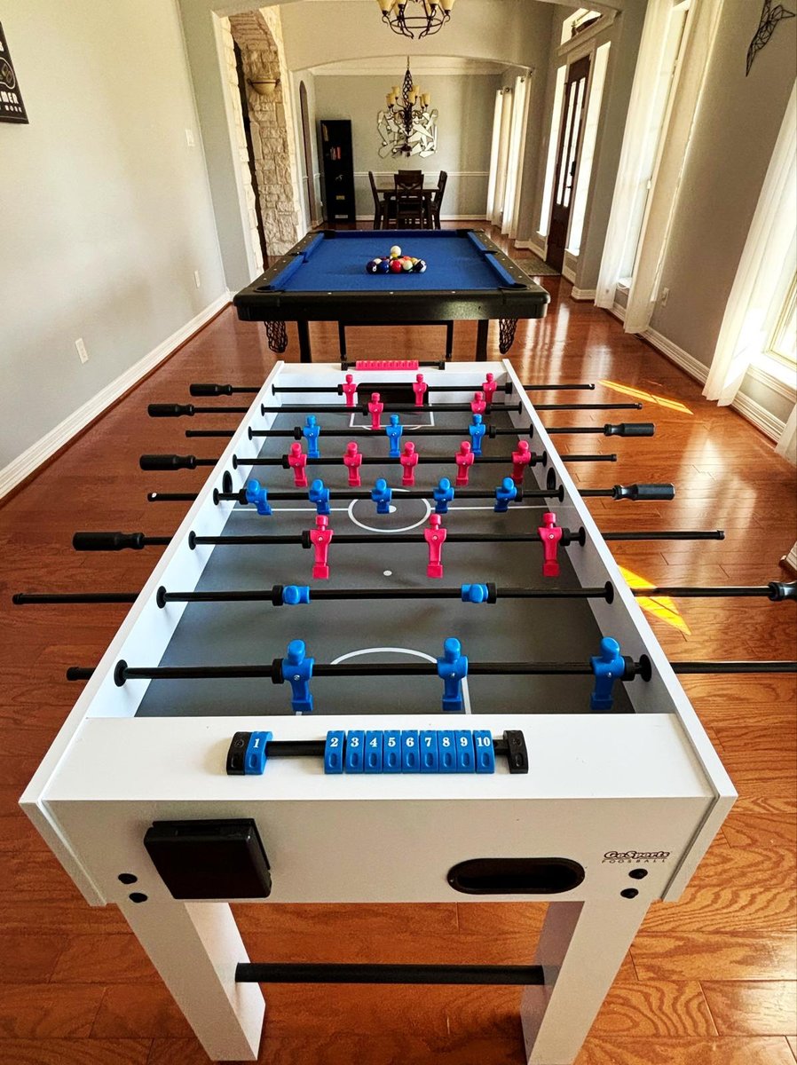 Foosball table and pool table in spacious game room